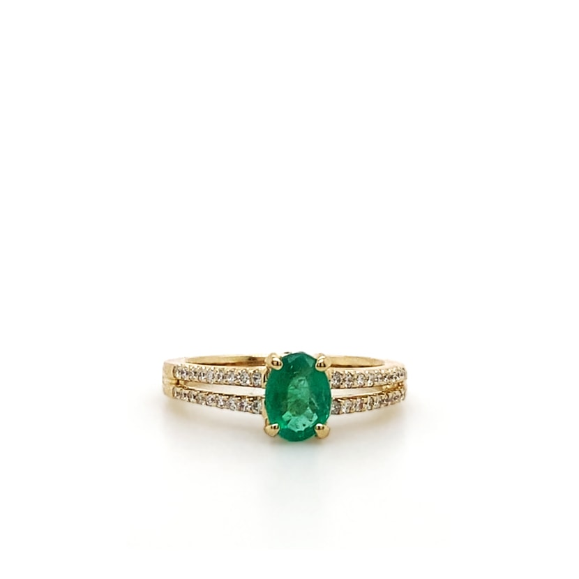 14k Yellow Gold Oval Emerald Ring mounted on a Diamond Band